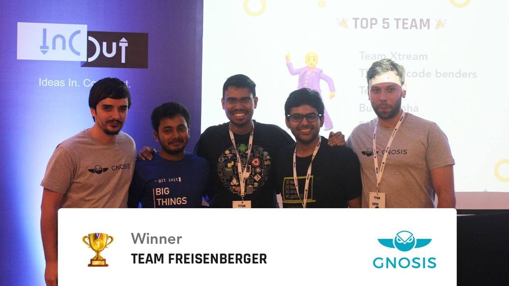 Team Freisenberger receiving the winner award on stage at the InOut hackathon next to a Gnosis banner